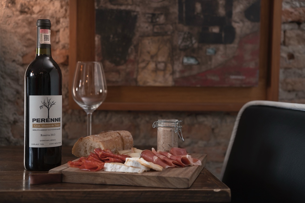 Red wine served in a restaurant setting paired with food on the table