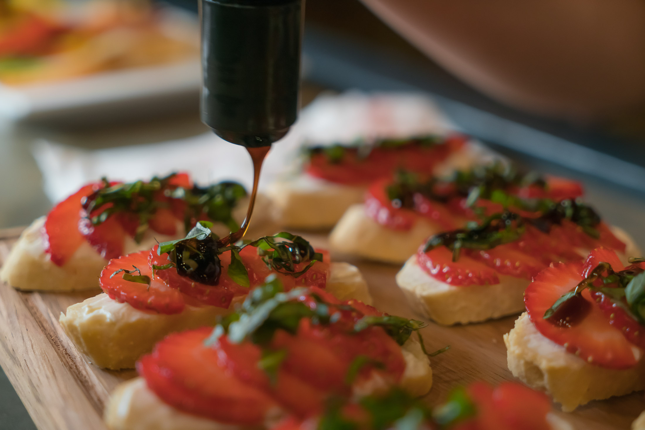 Close-up of dessert tapas with strawberries and syrup in natural outdoor light