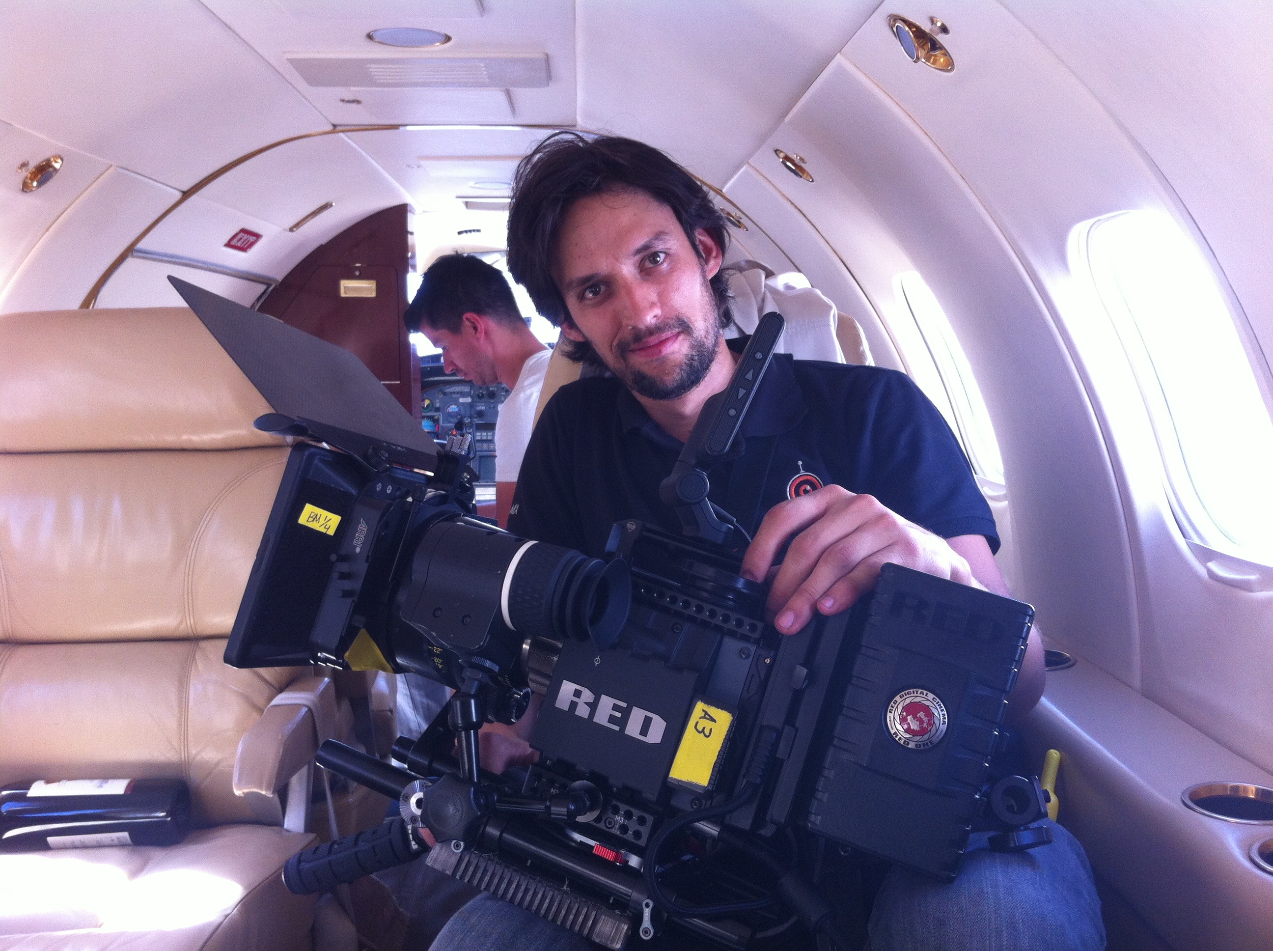 Alejandro Roa during his first feature film project, operating a cinema camera inside a private jet.
